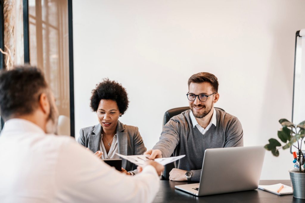 the multicultural businesspeople are sitting at the corporate fi